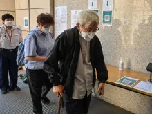 Cardinal Joseph Zen (right)  arrives at a court for his trial in Hong Kong on Sept. 26, 2022.