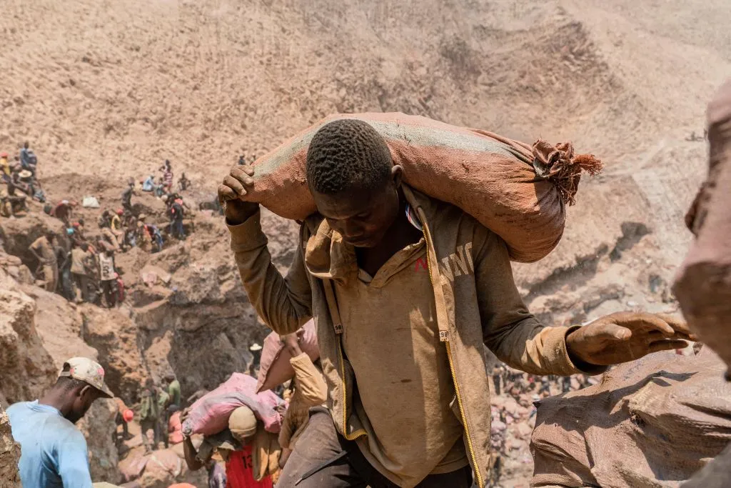 An artisanal miner carries a sack of ore at the Shabara artisanal mine near Kolwezi in the Democratic Republic of Congo on Oct.12, 2022.?w=200&h=150