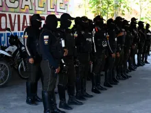 Members of the National Police prepare before going out to patrol the streets of Duran, city neighbouring Guayaquil, Ecuador, on Nov. 5, 2022. Special police forces continued on Friday, Nov. 4, 2022 to transfer imprisoned criminal gang leaders who have unleashed terror in Guayaquil as part of the government's "open war" against drug trafficking.