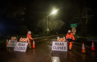 Road workers close the access to the 101 Freeway at Olive Mill Road as a result of San Ysidro Creek overflowing due to heavy rainfall in the area on Jan. 9, 2023, in Montecito, California. The town was ordered evacuated on Monday with firefighters warning mudslides could engulf homes. Montecito, a town of about 9,000 people, was expected to get up to eight inches of rain in 24 hours —on hillsides already sodden by weeks of downpours. Photo by APU GOMES/AFP via Getty Images