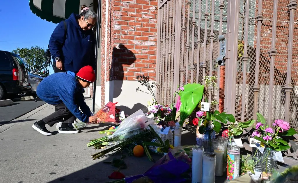 Inez Arakaki and her son Zachary place flowers on a makeshift memorial site in front of the Star Dance Studio in Monterey Park, California, on Jan. 23, 2023, where 10 people were shot dead late on Jan. 21, 2023.  California police searched on Jan. 23, 2023 for what compelled a 72-year-old man of Asian descent to shoot dead 10 people as they celebrated Lunar New Year at a dance hall in the Los Angeles suburbs.?w=200&h=150