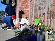 Inez Arakaki and her son Zachary place flowers on a makeshift memorial site in front of the Star Dance Studio in Monterey Park, California, on Jan. 23, 2023, where 10 people were shot dead late on Jan. 21, 2023.  California police searched on Jan. 23, 2023 for what compelled a 72-year-old man of Asian descent to shoot dead 10 people as they celebrated Lunar New Year at a dance hall in the Los Angeles suburbs.