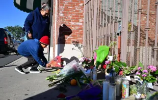 Inez Arakaki and her son Zachary place flowers on a makeshift memorial site in front of the Star Dance Studio in Monterey Park, California, on Jan. 23, 2023, where 10 people were shot dead late on Jan. 21, 2023.  California police searched on Jan. 23, 2023 for what compelled a 72-year-old man of Asian descent to shoot dead 10 people as they celebrated Lunar New Year at a dance hall in the Los Angeles suburbs. Photo by FREDERIC J. BROWN/AFP via Getty Images