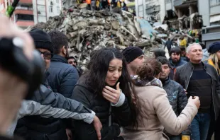 A woman reacts as rescuers search for survivors through the rubble of collapsed buildings in Adana, Turkey, on Feb. 6, 2023, after a 7.8-magnitude earthquake struck the country’s southeast. The combined death toll for Turkey and Syria after the region’s strongest quake in nearly a century is in the thousands. Photo by CAN EROK/AFP via Getty Images