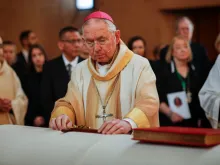 Archbishop José H. Gomez places the Book of Gospels and a cross on the coffin of Bishop David O'Connell before leading a procession at Cathedral of Our Lady of the Angels, in downtown Los Angeles on March 3, 2023.