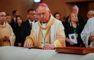 Archbishop José H. Gomez places the Book of Gospels and a cross on the coffin of Bishop David O'Connell before leading a procession at Cathedral of Our Lady of the Angels, in downtown Los Angeles on March 3, 2023. Photo by Jay L. Clendenin-Pool/Getty Images