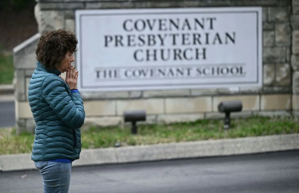 A woman prays at a makeshift memorial for victims outside the Covenant School building at the Covenant Presbyterian Church on March 28, 2023, following the March 27, 2023, shooting at the school in Nashville, Tennessee.?w=200&h=150