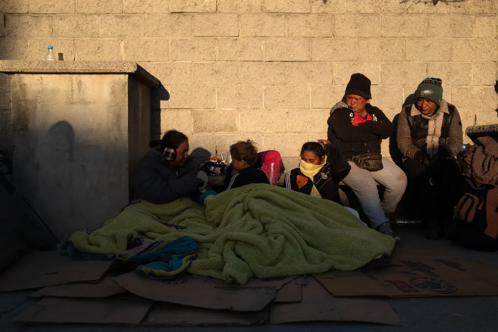 Migrants wake up after spending the night outside the immigration detention center where at least 38 migrants died during a fire in Ciudad Juarez, Chihuahua state, Mexico, on March 29, 2023.?w=200&h=150