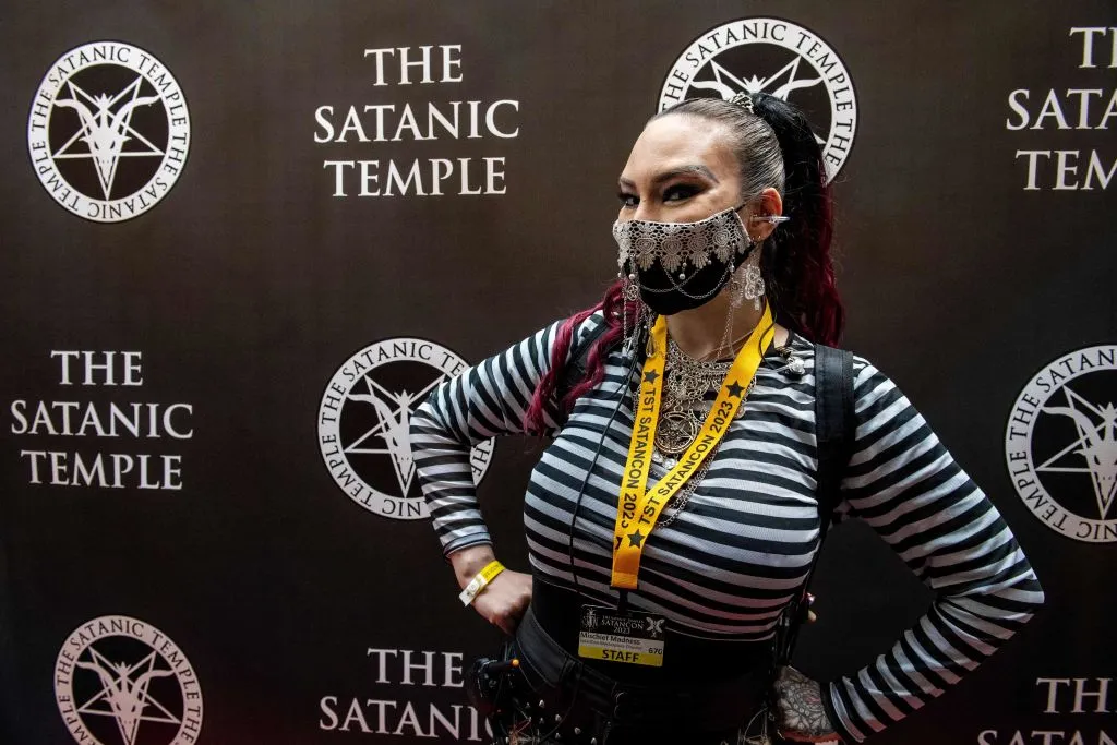 Mischief Madness, a staff member at the convention, wears a custom-decorated mask with a pentagram on it at Satan Con in Boston, Massachusetts, on April 28, 2023.?w=200&h=150