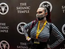 Mischief Madness, a staff member at the convention, wears a custom-decorated mask with a pentagram on it at Satan Con in Boston, Massachusetts, on April 28, 2023.