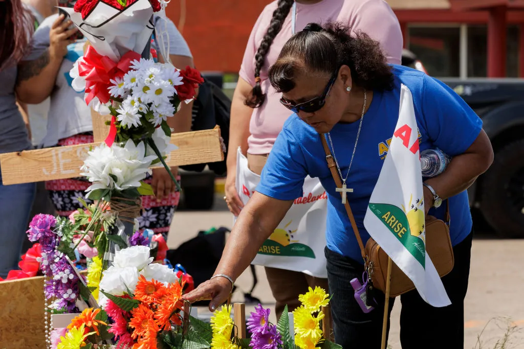 A woman touches crosses setup at a memorial during a vigil on May 8, 2023, in Brownsville, Texas. The vigil was held in remembrance of the eight people killed May 7, 2023, and several injured after a man allegedly drove his car through a group of migrants waiting at a bus stop.?w=200&h=150