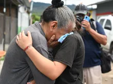 Relatives of inmates of the Women's Center for Social Adaptation (CEFAS) prison cry outside the detention center after a fire following a brawl between inmates in Tamara, some 25 kilometers from Tegucigalpa, Honduras, on June 20, 2023.