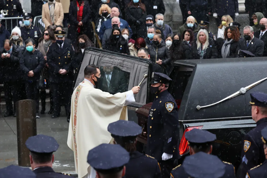 A priest sprinkles holy water on the casket of fallen NYPD Officer Jason Rivera during his funeral at St. Patrick's Cathedral, Jan. 28, 2022 in New York City. The 22-year-old NYPD officer was shot and killed on January 21 in Harlem while responding to a domestic disturbance call. Rivera's partner, Officer Wilbert Mora, also died from injuries suffered in the shooting.?w=200&h=150