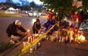 Mourners light candles at a makeshift memorial outside of Tops market on May 16, 2022 in Buffalo, New York. A gunman opened fire at the store yesterday killing ten people and wounding another three. The attack was believed to be motivated by racial hatred. Scott Olson/Getty Images.