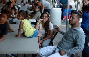 Dainelys Soto, Genesis Contreras, and Daniel Soto, who arrived from Venezuela after crossing the U.S. border from Mexico, wait for dinner at a hotel provided by the Annunciation House on Sept. 22, 2022, in El Paso, Texas. Credit: Joe Raedle/Getty Images