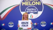 Giorgia Meloni, leader of the Fratelli d'Italia (Brothers of Italy) holds a “Thank You Italy” sign during a press conference at the party electoral headquarters on Sept. 25, 2022 in Rome.