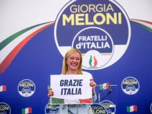 Giorgia Meloni, leader of the Fratelli d'Italia (Brothers of Italy) holds a “Thank You Italy” sign during a press conference at the party electoral headquarters on Sept. 25, 2022 in Rome.
