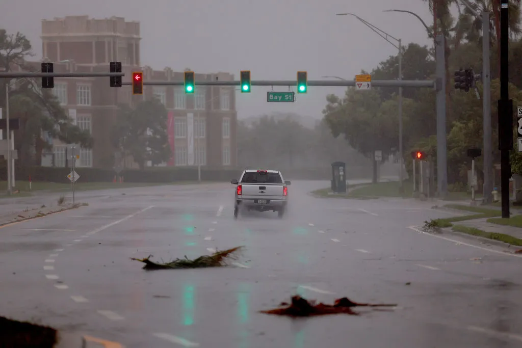 A vehicle drives through the winds and rain from Hurricane Ian on Sept. 28, 2022, in Sarasota, Florida. Ian is hitting the area as a likely Category 4 hurricane.?w=200&h=150