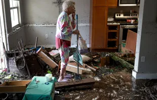 A woman looks over her apartment after floodwater inundated it when Hurricane Ian passed through the area on Sept. 29, 2022 in Fort Myers, Florida. The hurricane brought high winds, storm surge, and rain to the area, causing severe damage. Photo by Joe Raedle/Getty Images