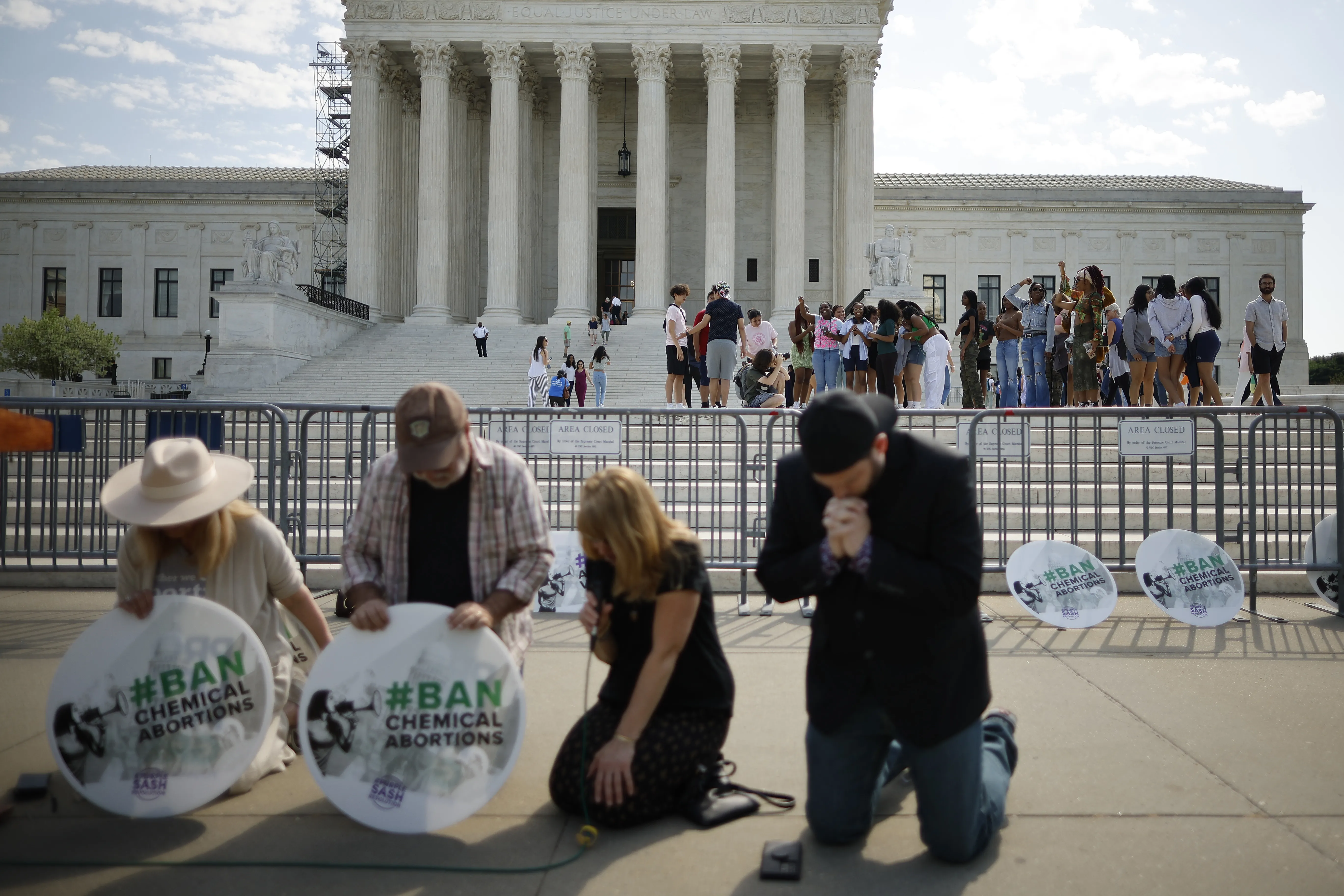 Katie Mahoney, Rev. Pat Mahoney, Peggy Nienaber of Faith and Liberty, and Mark Lee Dickson of Right to Life East Texas pray in front of the U.S. Supreme Court on April 21, 2023, in Washington, D.C.?w=200&h=150