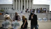 Katie Mahoney, Rev. Pat Mahoney, Peggy Nienaber of Faith and Liberty, and Mark Lee Dickson of Right to Life East Texas pray in front of the U.S. Supreme Court on April 21, 2023, in Washington, D.C.