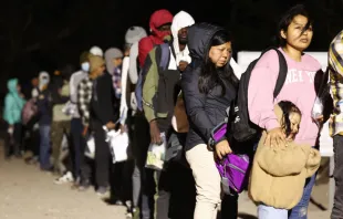 Immigrants seeking asylum in the United States stand in line to be processed by U.S. Border Patrol agents in the early morning hours after crossing into Arizona from Mexico on May 10, 2023, in Yuma, Arizona. Credit: Mario Tama/Getty Images