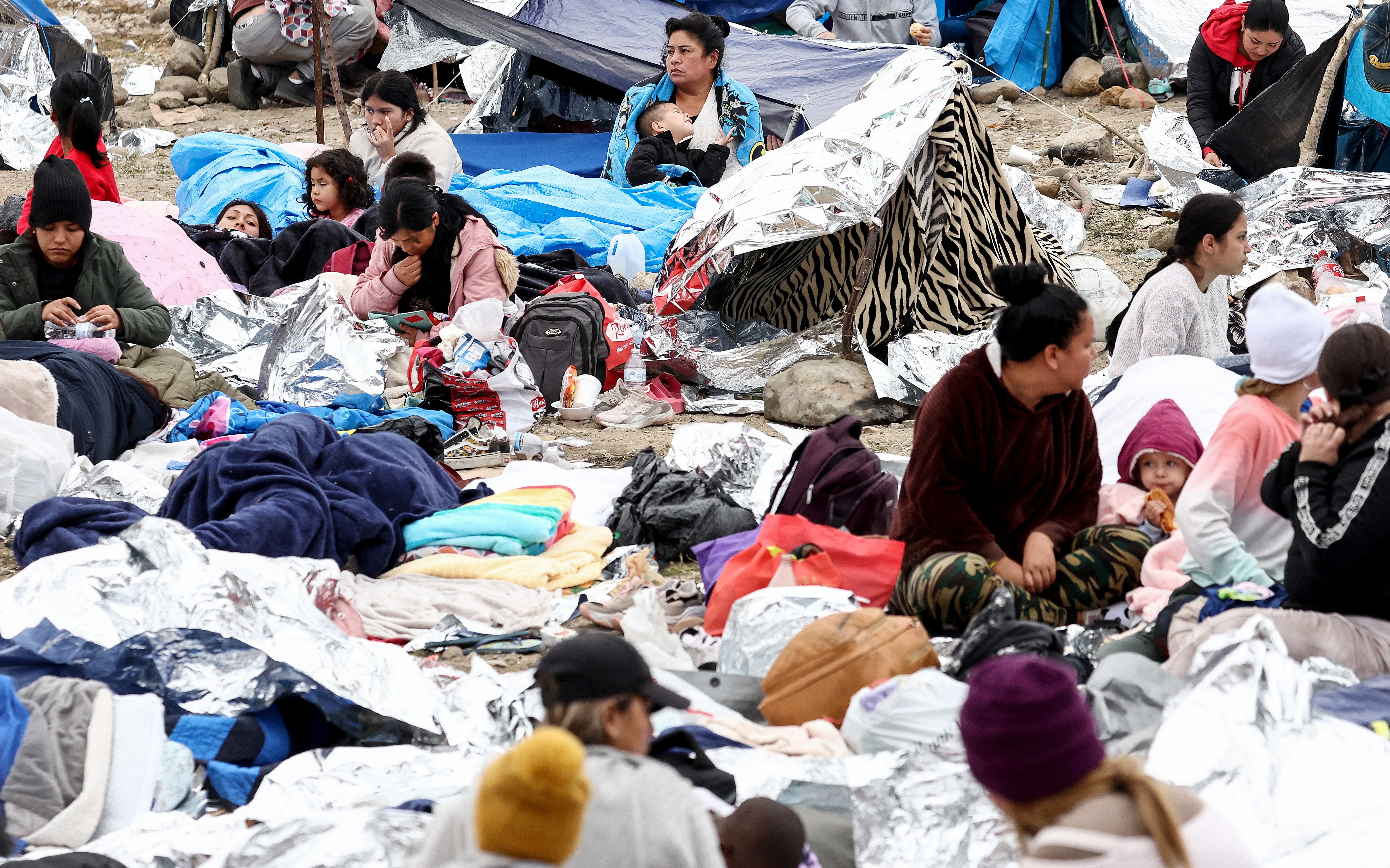 Immigrants gather at a makeshift camp stranded between border walls between the U.S. and Mexico on May 13, 2023, in San Diego, California.?w=200&h=150