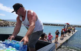 Volunteers load water onto a boat to be transported to West Maui from the Kihei boat landing on Aug. 13, 2023 in Kihei, Hawaii. Credit: Justin Sullivan/Getty Images
