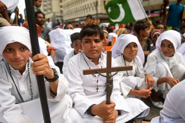 A Christian boy holds a crucifix during a protest in Karachi on Aug. 22, 2023, to condemn the attack on churches in Pakistan. More than 80 Christian homes and 19 churches were vandalized in an hourslong riot in Jaranwala in Punjab province on Aug. 16 after unverified reports that a Koran had been desecrated. Credit: RIZWAN TABASSUM/AFP via Getty Images