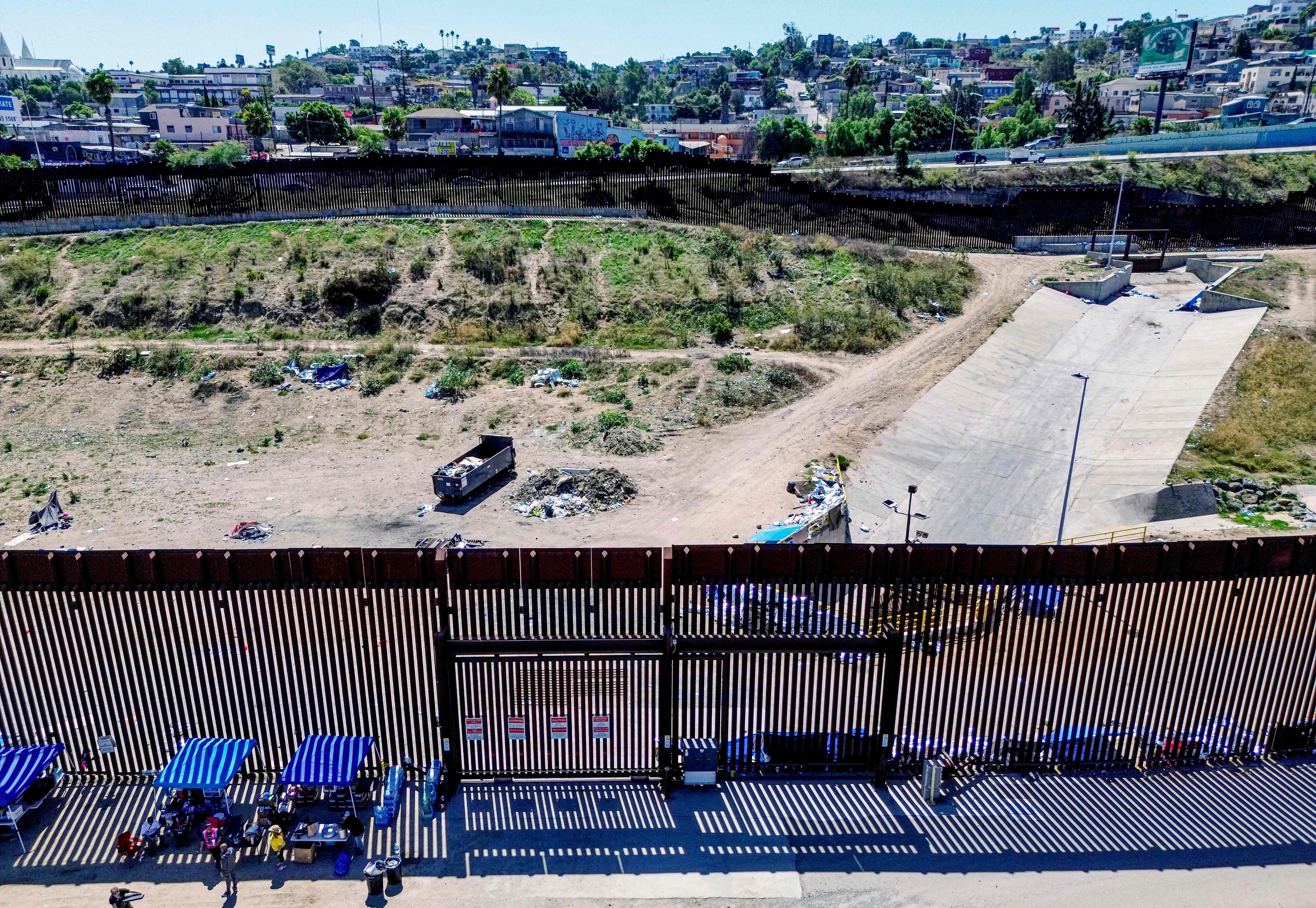 This aerial picture taken on Sept. 14, 2023, shows the U.S.-Mexico border fence with camp shelters left by migrants in San Ysidro, California.?w=200&h=150