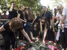 Family and friends of May Naim, 24, who was murdered by Palestinians militants at the "Supernova" festival near the Israeli border with Gaza Strip, react during her funeral on Oct. 11, 2023, in Gan Haim, Israel.