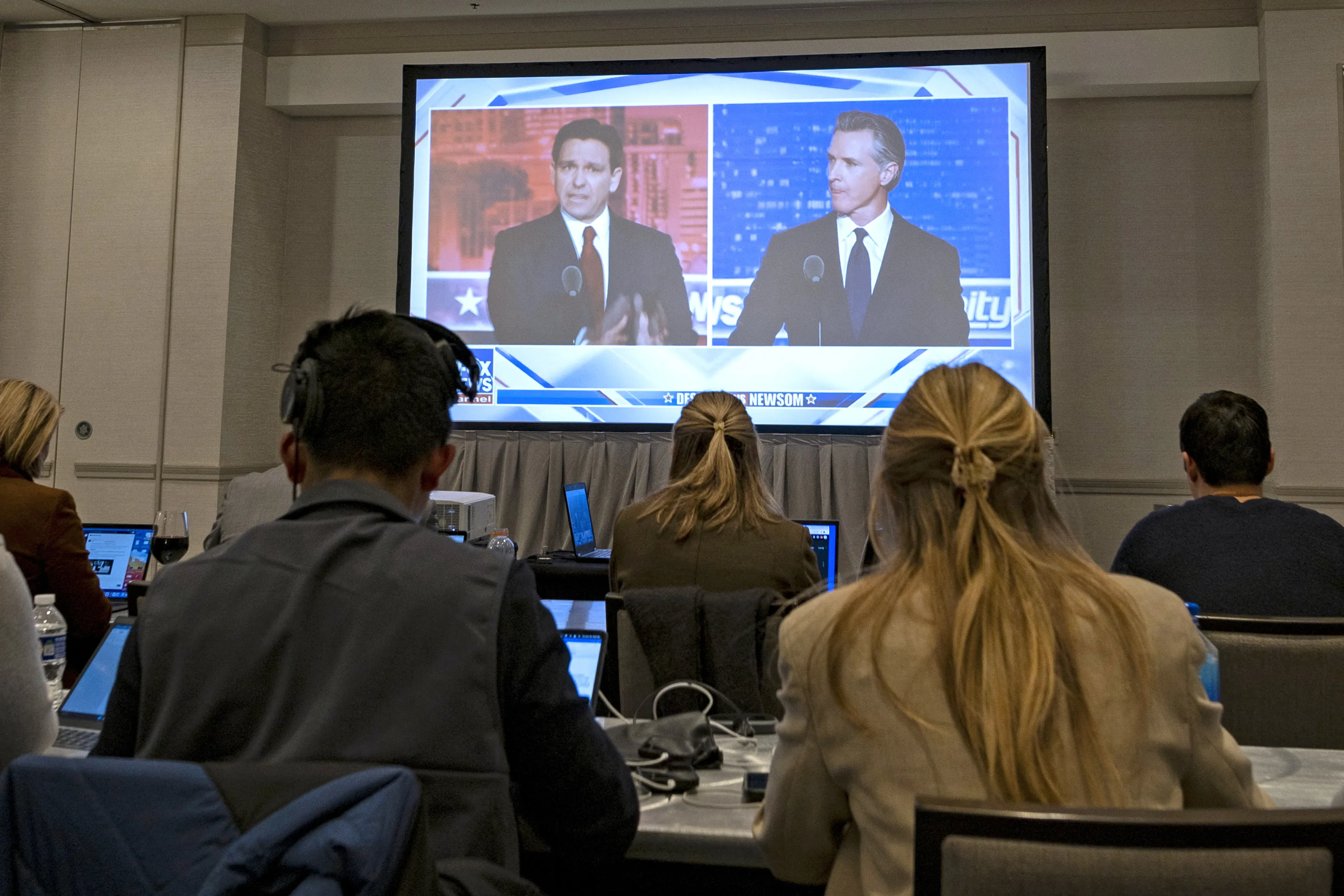 Florida governor and Republican presidential hopeful Ron DeSantis (left) and California Gov. Gavin Newsom appear on screen from the press room during a debate held by Fox News in Alpharetta, Georgia, on Nov. 30, 2023.?w=200&h=150