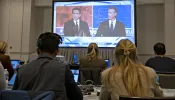 Florida governor and Republican presidential hopeful Ron DeSantis (left) and California Gov. Gavin Newsom appear on screen from the press room during a debate held by Fox News in Alpharetta, Georgia, on Nov. 30, 2023.