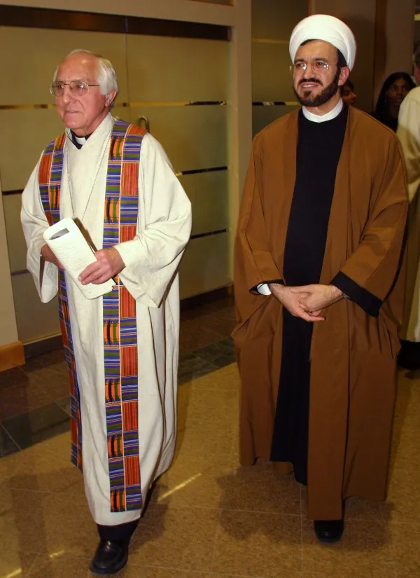 Auxiliary Bishop Thomas Gumbleton of the Catholic Archdiocese of Detroit and Bishop Ibrahim Ibrahim of the Chaldean Catholic Diocese U.S.A. enter the Greater Grace Temple to participate in an interfaith antiwar prayer service and rally March 16, 2003, in Detroit. Credit: Bill Pugliano/Getty Images