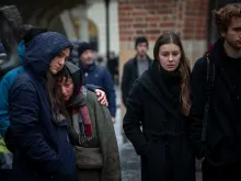 People mourn outside the Charles University building following a mass shooting on Dec. 22, 2023, in Prague, Czech Republic. Fourteen people were killed and 25 injured. Police say the gunman was a 24-year-old student at the university.