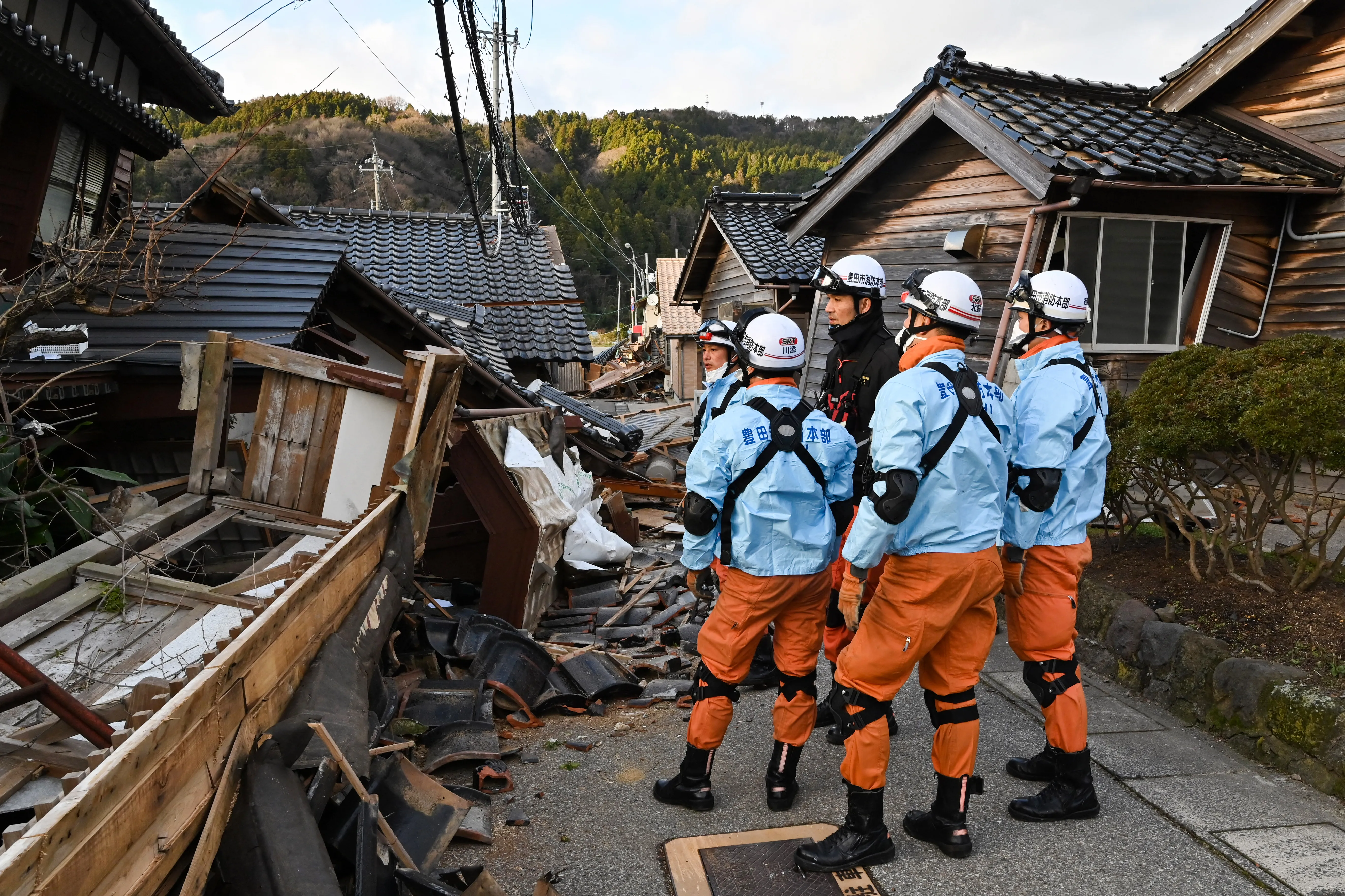 Firefighters inspect collapsed wooden houses in Wajima, Ishikawa Prefecture, on Jan. 2, 2024, a day after a major 7.6-magnitude earthquake struck the Noto region in Ishikawa Prefecture.?w=200&h=150