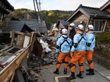 Firefighters inspect collapsed wooden houses in Wajima, Ishikawa Prefecture, on Jan. 2, 2024, a day after a major 7.6-magnitude earthquake struck the Noto region in Ishikawa Prefecture.