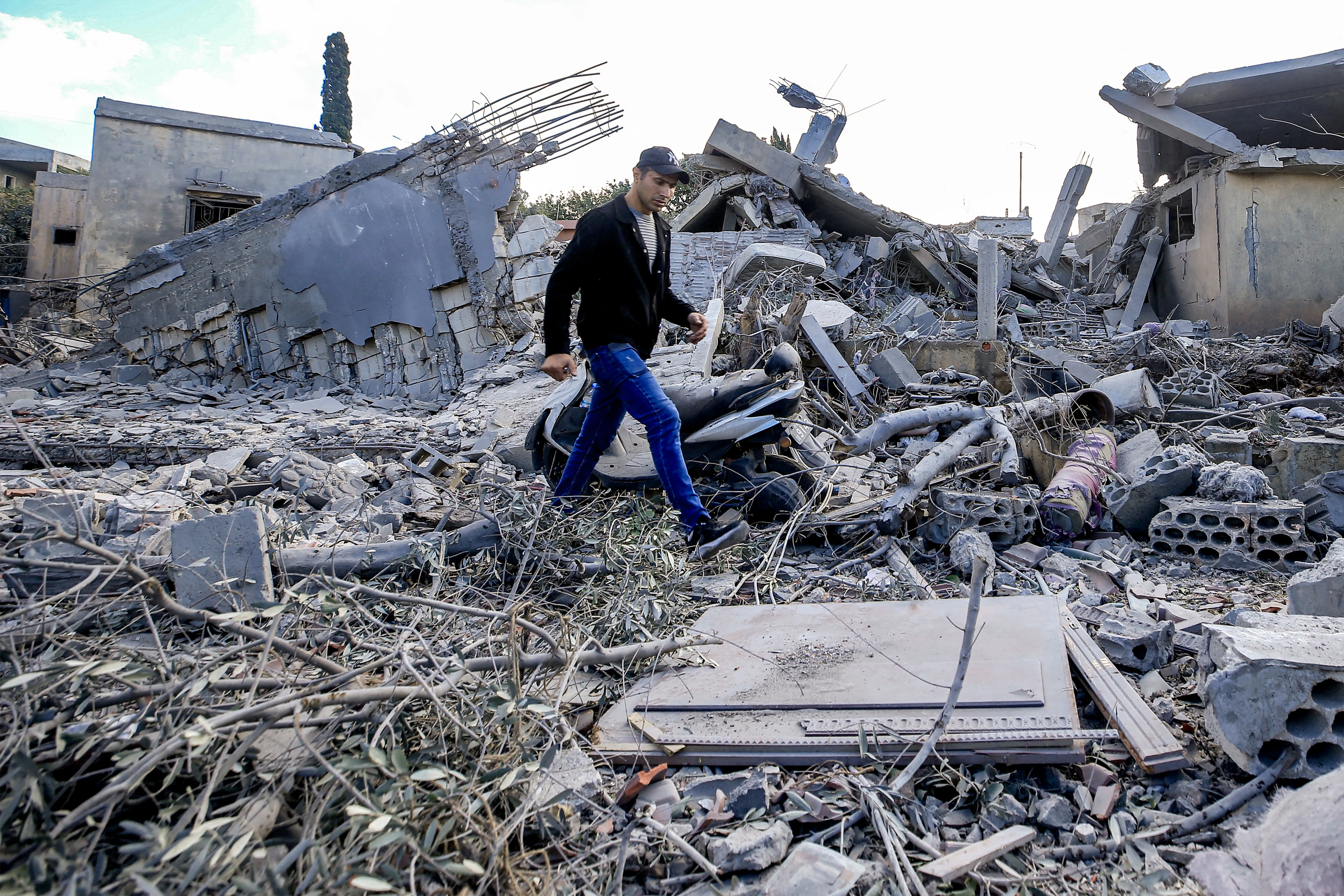 A man walks through the rubble of destroyed buildings following strikes on the the town of Naqura in southern Lebanon close to the border with northern Israel on Jan. 4, 2024. Four Hezbollah fighters were killed overnight in southern Lebanon, the Iran-backed movement announced on Jan. 4, in what Lebanese state media said were Israeli strikes on the border town of Naqura.?w=200&h=150