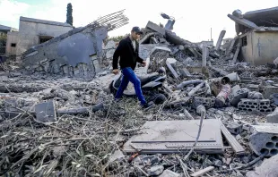 A man walks through the rubble of destroyed buildings following strikes on the the town of Naqura in southern Lebanon close to the border with northern Israel on Jan. 4, 2024. Four Hezbollah fighters were killed overnight in southern Lebanon, the Iran-backed movement announced on Jan. 4, in what Lebanese state media said were Israeli strikes on the border town of Naqura. Credit: Photo by AFP via Getty Images