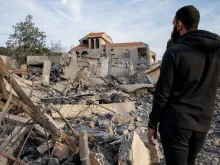 A man checks a destroyed building on Jan. 8, 2024, after an Israeli air raid in the village of Kfar Kila in southern Lebanon, amid ongoing cross-border tensions as fighting continues between Israel and Hamas militants in Gaza.