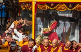 A Catholic devotee kisses the glass cover of the Black Nazarene statue during the annual procession for the feast of the Black Nazarene in Manila, Philippines, on Jan. 9, 2024. Hundreds of thousands of Catholic faithful swarmed a historic statue of Jesus Christ as it was pulled through the streets of the Philippine capital in one of the world’s biggest displays of religious devotion. Credit: EARVIN PERIAS/AFP via Getty Images