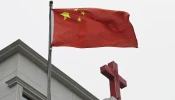 This photo taken on Jan. 15, 2024, shows a Chinese flag fluttering below a cross on a Christian church in Pingtan, in China’s southeast Fujian province.