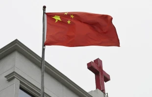 This photo taken on Jan. 15, 2024, shows a Chinese flag fluttering below a cross on a Christian church in Pingtan, in China’s southeast Fujian province. Credit: Photo by GREG BAKER/AFP via Getty Images