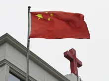 This photo taken on Jan. 15, 2024, shows a Chinese flag fluttering below a cross on a Christian church in Pingtan, in China's southeast Fujian province.