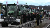 French farmers stand next to their tractors as they block the road during a demonstration at the French-German border in Ottmarsheim, eastern France, on Feb. 1, 2024, as part of nationwide protests called by several farmers’ unions over pay, tax, and regulations.