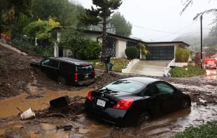 A person attempts to clear away debris from a mudslide as a powerful long-duration atmospheric river storm, the second in less than a week, continues to impact Southern California on Feb. 5, 2024, in Beverly Hills, California. Credit: Mario Tama/Getty Images