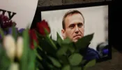 Photographs and flowers are left outside the Russian Embassy in London on Feb. 16, 2024, following the news of the death of Russian opposition leader Alexei Navalny.