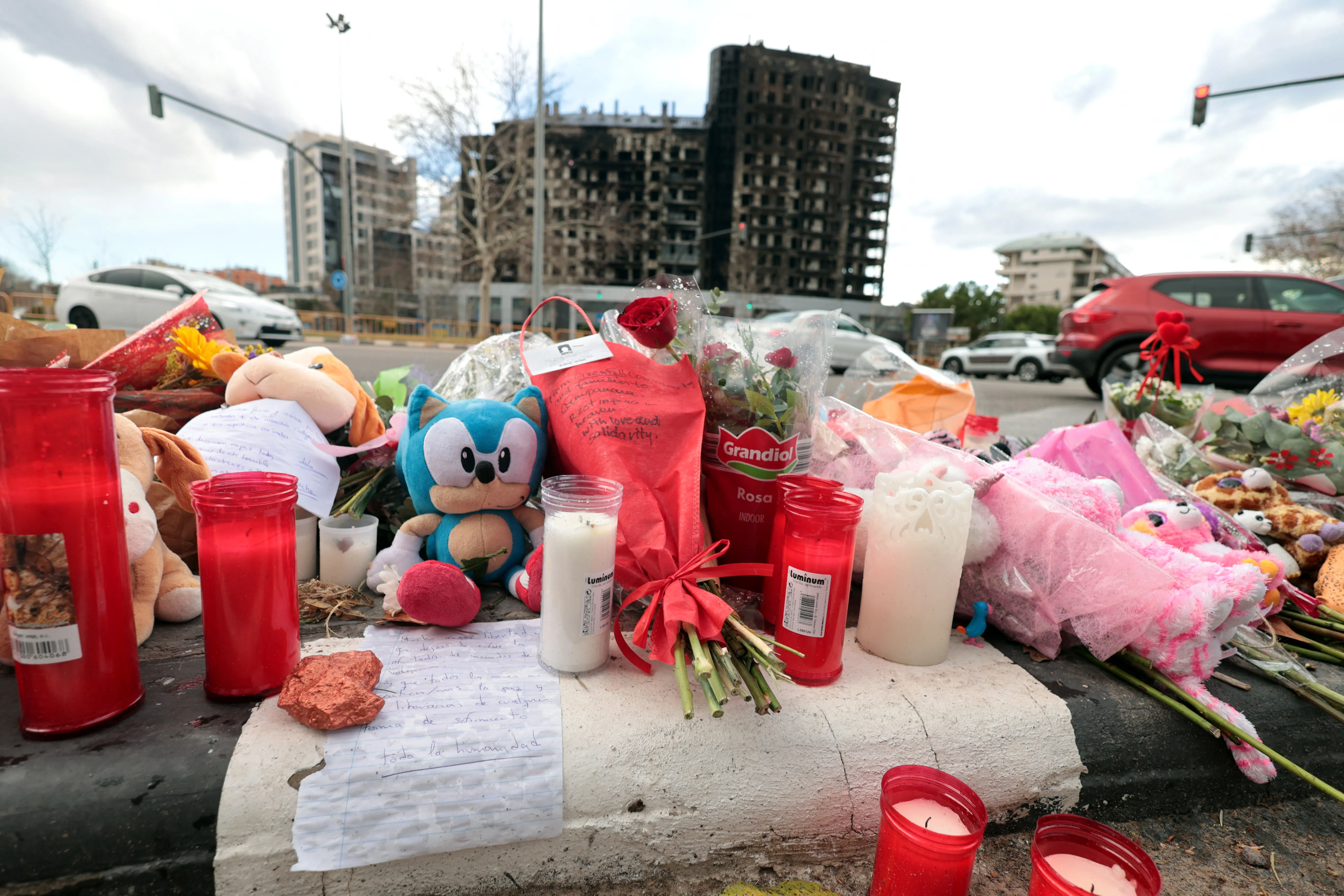 Flowers and candles are laid out on the sidewalk on Feb. 26, 2024, after a huge fire killed 10 people in a multi-story residential block in Valencia, Spain, on Feb. 22.?w=200&h=150