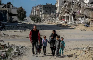 A Palestinian family walks past buildings destroyed in previous Israeli strikes in Gaza City on March 25, 2024, amid the ongoing conflict between Israel and Hamas. Credit: AFP via Getty Images