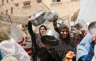 Palestinians carry empty pots during a demonstration held by the displaced Palestinians gathered in a protest carrying empty pots and pans asking for more relief aid and fuel to reach Gaza strip in Deir al-Balah, central Gaza, on Thursday, April 25, 2024. Credit: SAEED JARAS/Middle East Images/AFP via Getty Images
